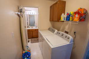 Laundry room with washing machine and clothes dryer and cabinet space