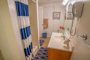 Full bath featuring vanity and shower / bath combo with shower curtain