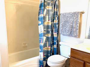 Full Primary Bathroom featuring vanity and shower / bathtub combination with curtain