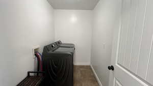 Laundry area with separate washer and dryer and baseboards