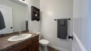 Bathroom featuring vanity and dark tile patterned floors