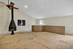 Shop loft with high vaulted ceiling and a wood stove