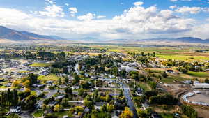 View of property location featuring nearby suburban area and a mountain backdrop