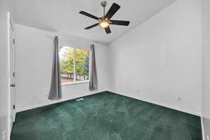 Primary bedroom featuring lofted ceiling and ceiling fan