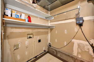 Basement utility area with washer and dryer hookups