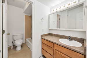 Basement bathroom with vanity and shower / tub combination