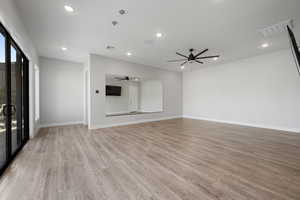 Unfurnished living room featuring light wood-style flooring, recessed lighting, and a ceiling fan