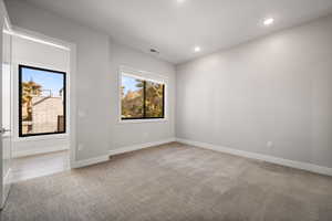 Spare room with light colored carpet, healthy amount of natural light, and recessed lighting
