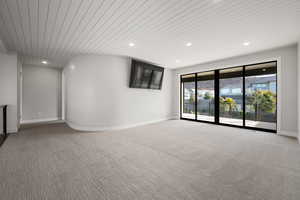 Spare room with recessed lighting, wooden ceiling, and light carpet