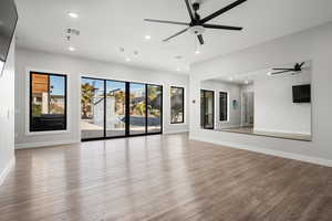 Unfurnished living room with recessed lighting, ceiling fan, and wood finished floors