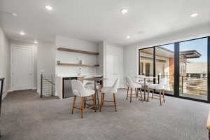 Dining room with light carpet and recessed lighting