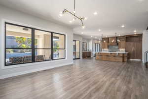 Unfurnished living room featuring recessed lighting and dark wood-type flooring