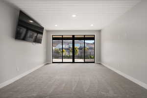 Unfurnished room featuring carpet, recessed lighting, and a residential view