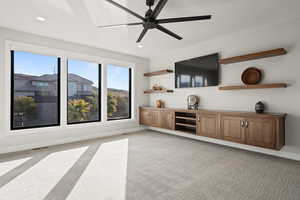 Living room featuring light carpet, ceiling fan, and recessed lighting