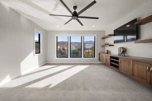 Unfurnished living room featuring light colored carpet, recessed lighting, and ceiling fan