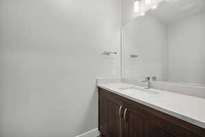 Bathroom with vanity and baseboards