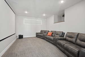 Home theater room with light carpet and recessed lighting