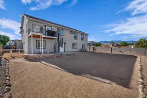 Back of house featuring a patio area, stucco siding, stairway, a fenced backyard, and a mountain view