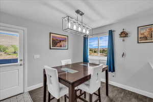 Dining area with dark wood finished floors