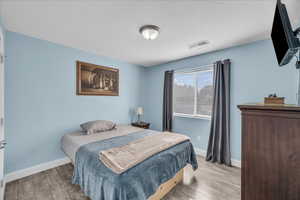 Bedroom with light wood finished floors