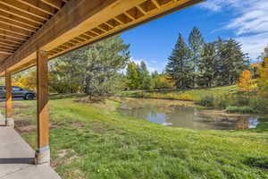 View of grassy yard with a water view