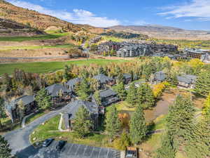 Aerial view of property's location featuring a mountain backdrop and nearby suburban area
