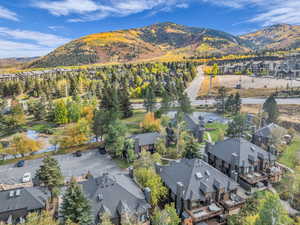 Aerial view of property and surrounding area with nearby suburban area and a mountainous background