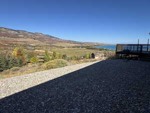 View of yard featuring a deck with water view