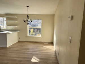 Dining area featuring a chandelier and light wood-style flooring