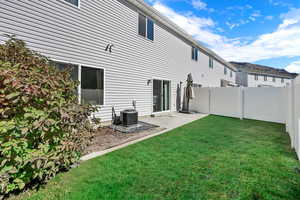 Back of house with a patio area and a fenced backyard
