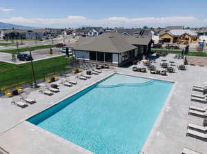 Community pool featuring a residential view, with a gym and playgrounds