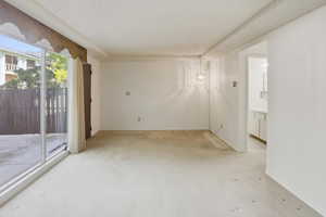Large family room with lots of light and windows looking out to front patio