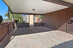 Back view of property showing carport, rear patio area and storage
