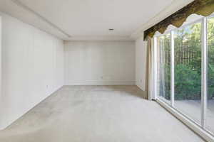 Large family room with lots of light and windows looking out to front patio