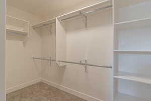 Walk in closet with carpet flooring
