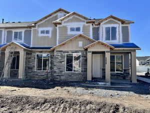 View of front of house with board and batten siding and stone siding