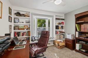 Office space with light colored carpet and a ceiling fan