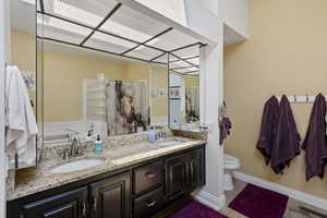 Full bath with double vanity and a garden tub