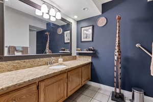 Bathroom featuring light tile patterned floors, vanity, and recessed lighting