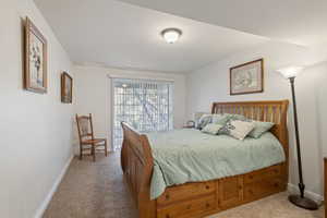 Bedroom featuring light colored carpet and baseboards