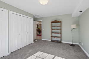 Unfurnished bedroom featuring carpet and a closet