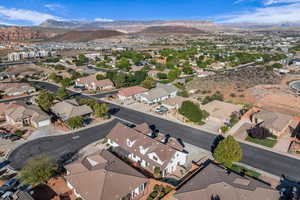Aerial overview of property's location featuring a mountainous background and nearby suburban area
