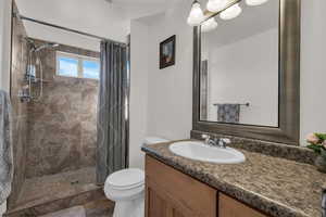 Full bath featuring vanity and a stall shower