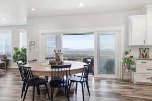 Dining area with plenty of natural light, dark wood finished floors, recessed lighting, and a mountain view