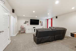 Living room with recessed lighting and light colored carpet
