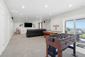 Game room with recessed lighting and light carpet