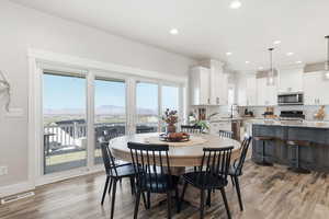 Dining space with light wood-type flooring, recessed lighting, and a mountain view