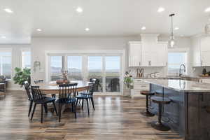 Dining area with recessed lighting and dark wood finished floors