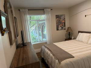 Bedroom with dark wood  floors and baseboards