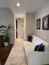 Living area featuring stone tile flooring and recessed lighting